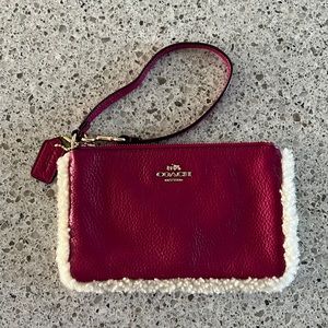 Pink coach clutch